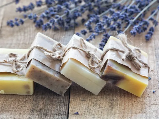 Handmade soap bars tied with twine on a wooden table